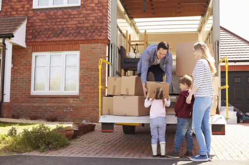 Man with van team using careful lifting and loading safety procedures