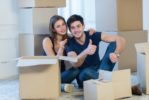 Moving crew securing household items inside a van with straps
