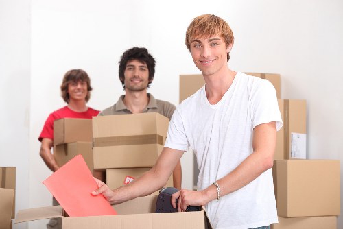 Removal team handling boxed items and furniture carefully
